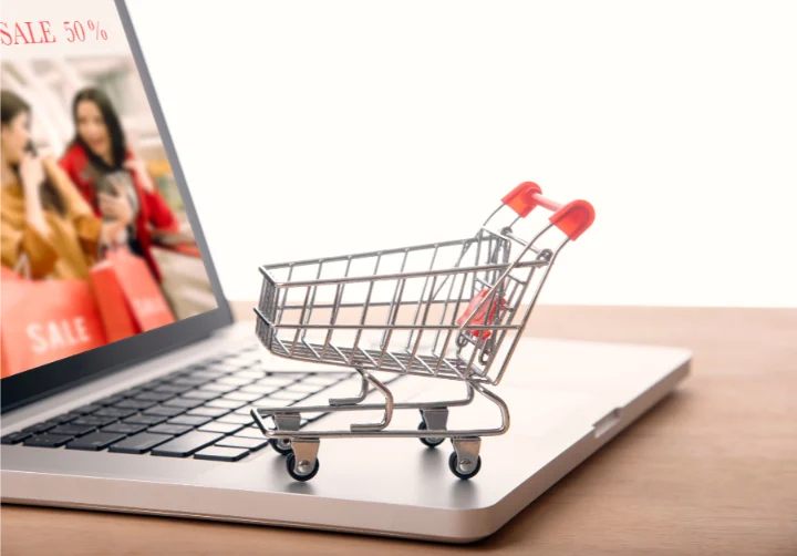 trolley on laptop computer with web page shopping online. e commerce marketing concept
